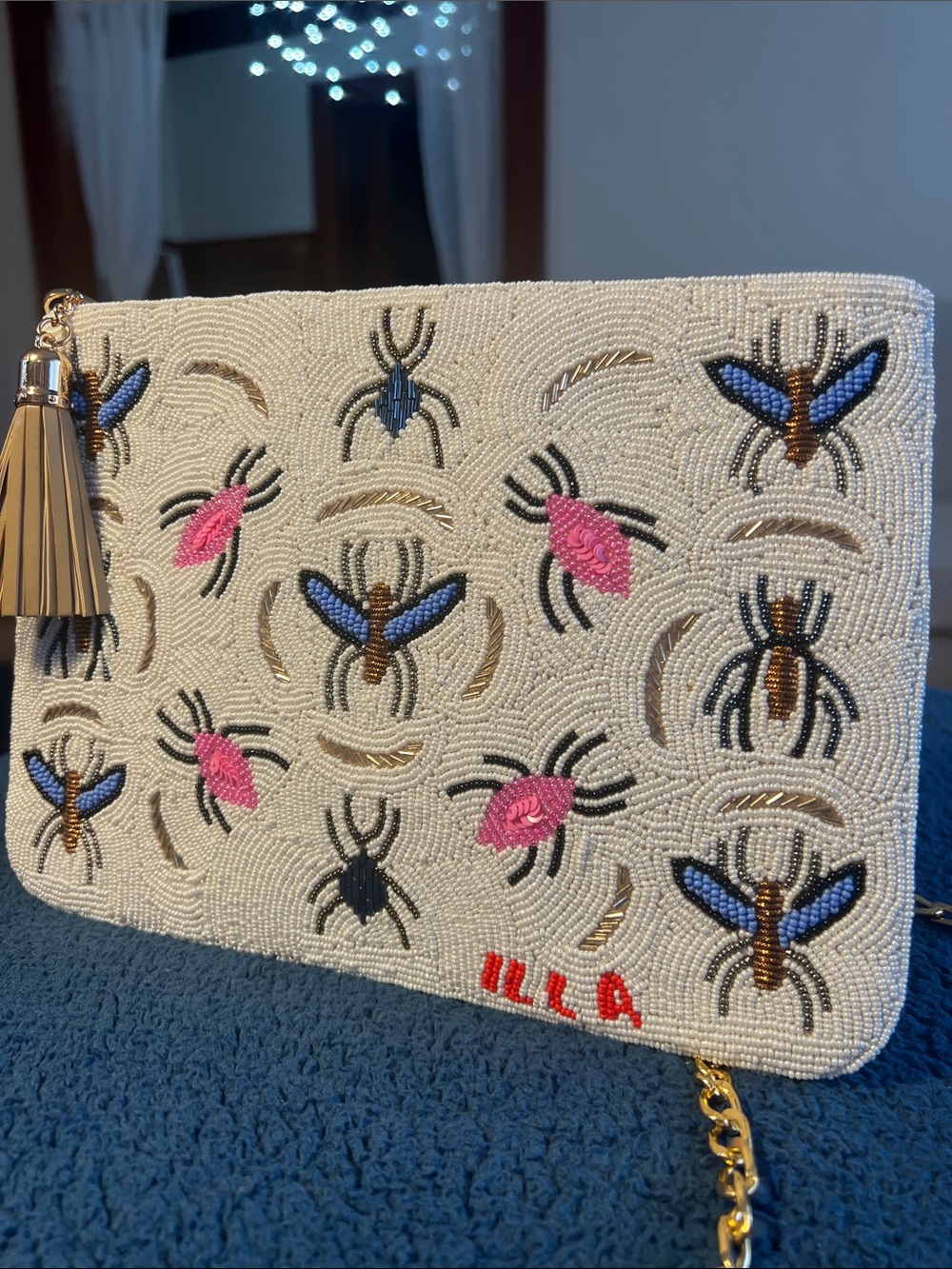 Handmade Beaded White Clutch with Pink & Blue Motif and Gold Tassel